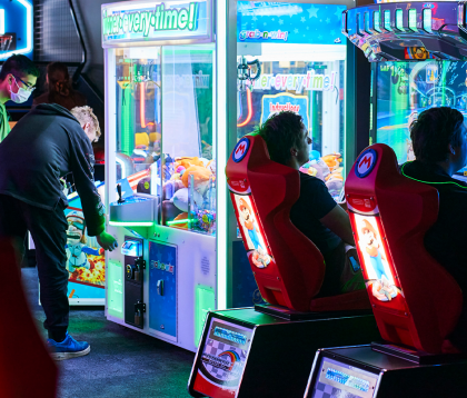 people playing arcade games